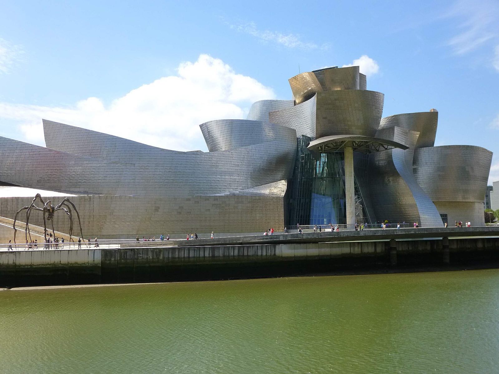 The titanium curves of the Guggenheim Museum Bilbao beside the river.
