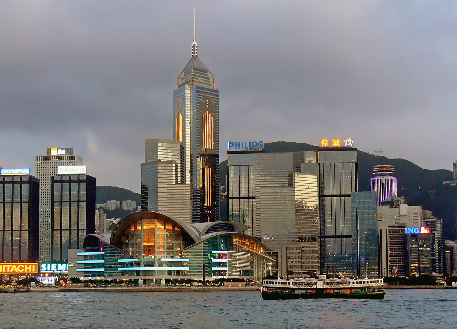 The Hong Kong Convention and Exhibition Centre on the harbour, with towers behind it.