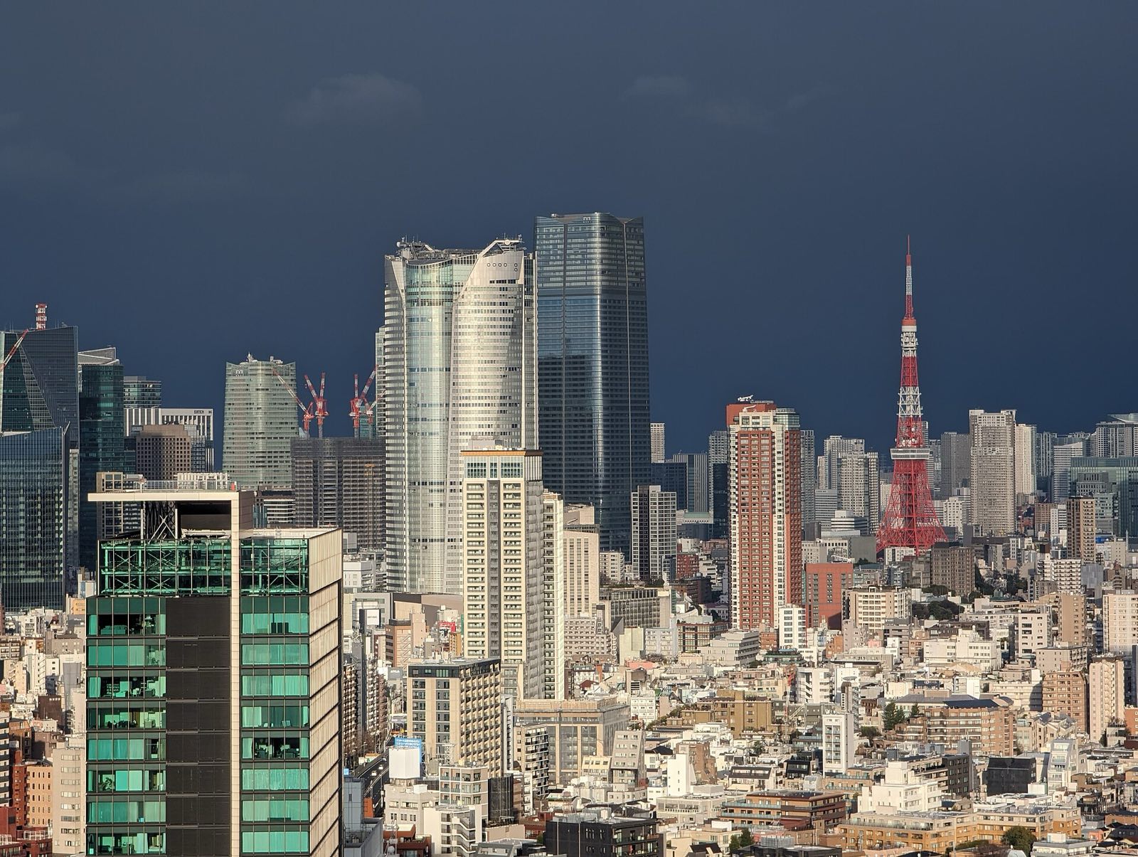 Roppongi Hills and Tokyo Tower under a dark sky.